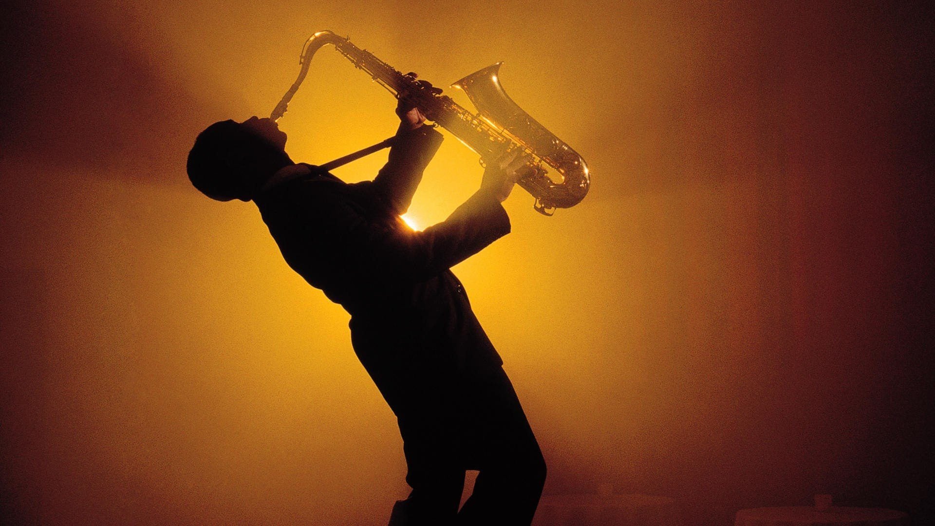 man playing saxophone silhouette
