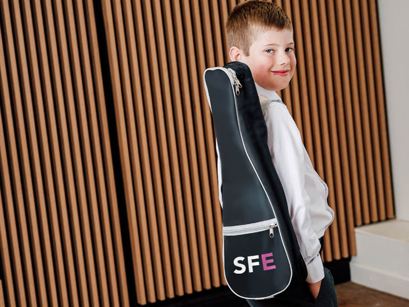 Student with SFE branding ukulele case